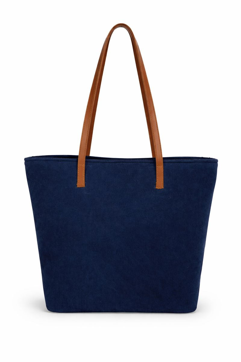 Navy blue tote bag with brown handles on a white background